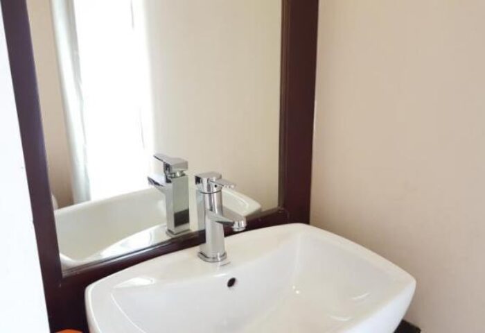 Bathroom sink and mirror at East Hotel, a gay-friendly hotel. Modern fixtures and clean design for gay travelers' comfort.