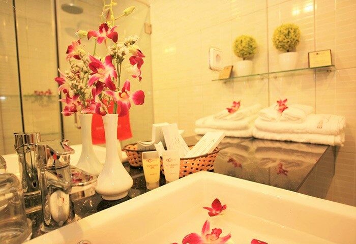 Eclipse Legend Hotel bathroom. Gay-friendly hotel with flowers, towels, and toiletries. Luxury travel for gay men.