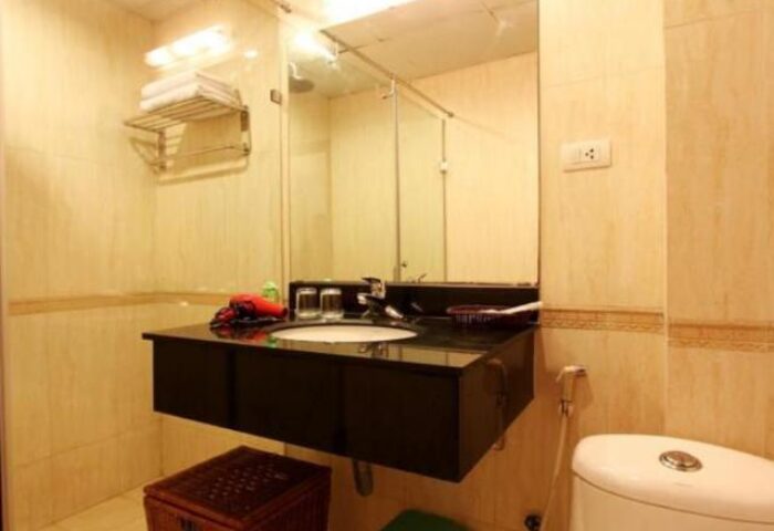 Bathroom at the gay-friendly Eclipse Legend Hotel. Sink, mirror, and toilet. A comfortable space for gay travelers.