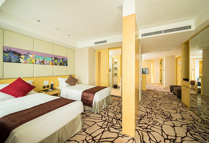 Eco Tree Hotel gay-friendly room with twin beds. Modern design, warm colors, and comfortable amenities. Ideal for gay travel.