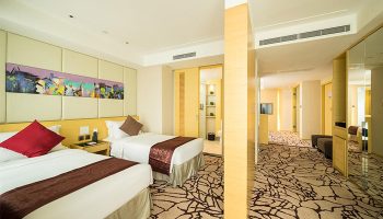 Eco Tree Hotel gay-friendly room with twin beds. Modern design, warm colors, and comfortable amenities. Ideal for gay travel.