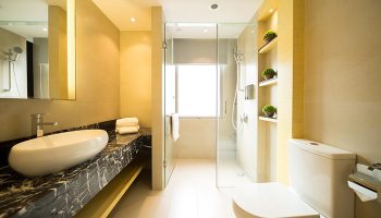 Eco Tree Hotel gay-friendly bathroom. Modern design with marble countertop, sleek sink, glass shower, and toilet. Ideal for gay men travel.