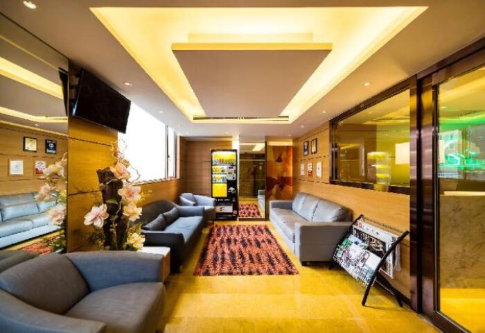 Eco Tree Hotel lobby. Gay-friendly hotel with modern design, sofas, TV, vending machine, and magazine rack. Great for gay men travel advice.