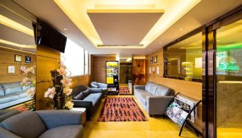 Eco Tree Hotel lobby. Gay-friendly hotel with modern design, sofas, TV, vending machine, and magazine rack. Great for gay men travel advice.