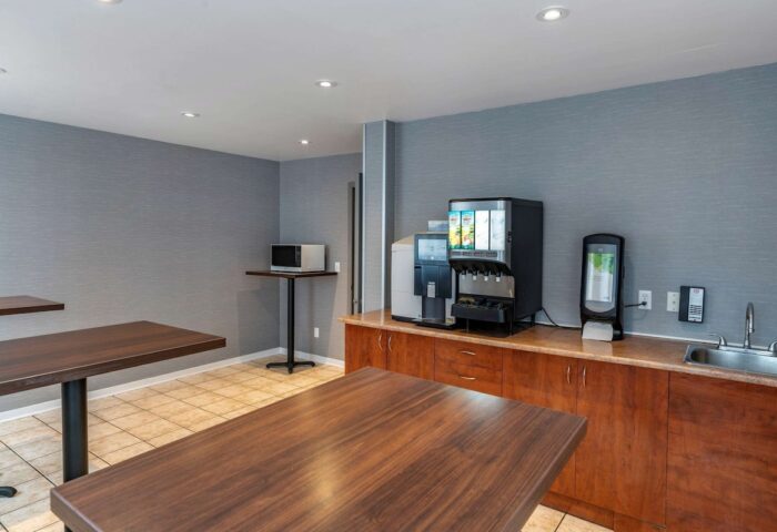 Econo Lodge gay-friendly hotel dining area. Tables, microwave, and beverage station with coffee and juice. Great for gay travel.