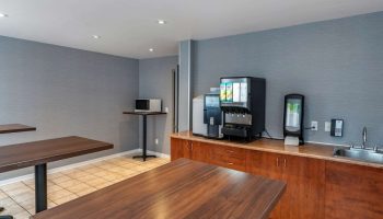 Econo Lodge gay-friendly hotel dining area. Tables, microwave, and beverage station with coffee and juice. Great for gay travel.