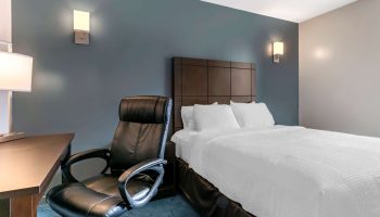 Econo Lodge hotel room. Gay-friendly travel lodging with a comfy bed, desk, and chair. A good choice for gay men's travel.