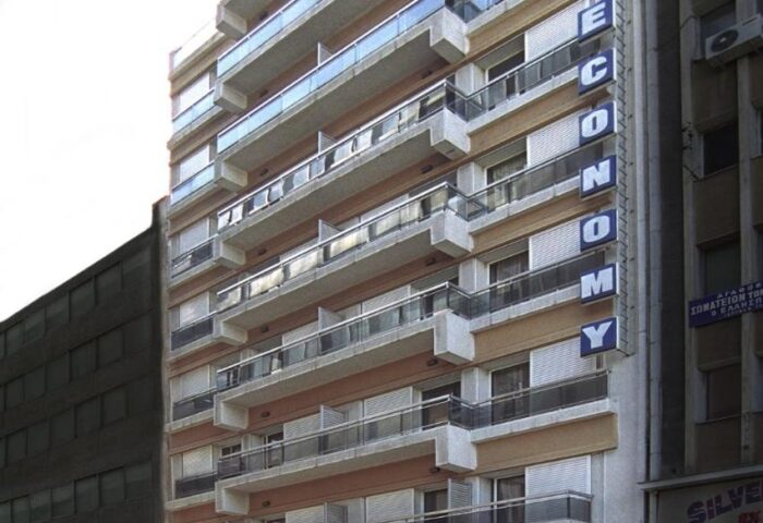 Exterior of Economy Hotel, a gay-friendly hotel. The building has multiple floors with balconies. Great choice for gay travelers.