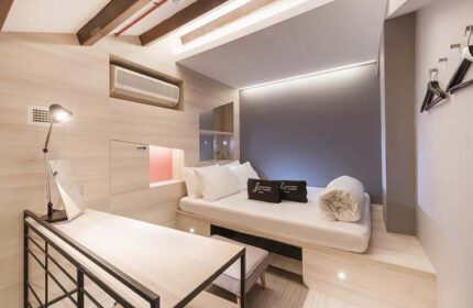Eighteen By Three Cabins interior. This gay-friendly hotel features compact rooms with a bed, desk, and modern design for gay men travelers.