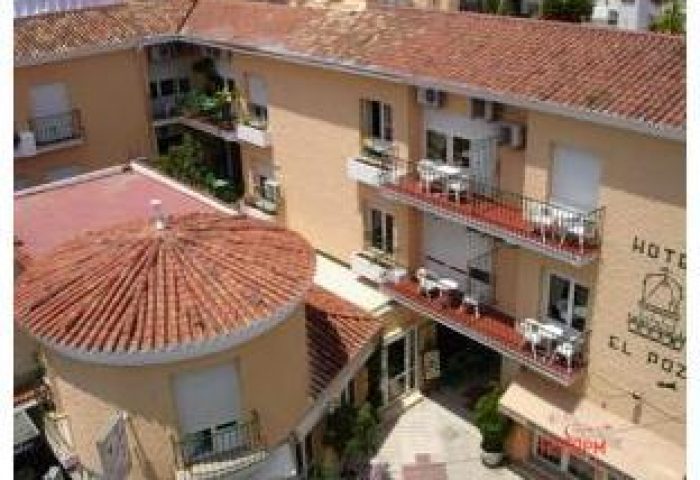 El Pozo, gay-friendly hotel. Exterior view of the hotel building with balconies. Gay travel advice for finding welcoming accommodations.