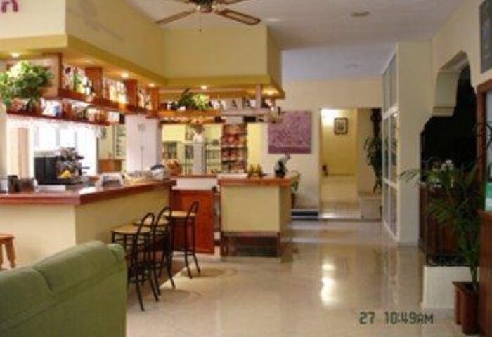 El Pozo Gay-Friendly Hotel bar area. Interior view of the hotel bar, seating, and decor. A welcoming space for gay travelers.