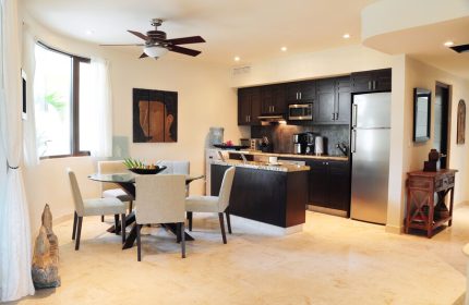El Taj Oceanfront Condo Hotel kitchen and dining area. Gay-friendly hotel with modern appliances, dining table and chairs. Upscale beachside condo.