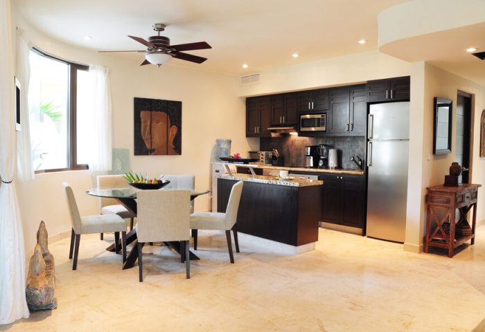 El Taj Oceanfront Condo Hotel kitchen and dining area. Gay-friendly hotel with modern appliances, dining table and chairs. Upscale beachside condo.