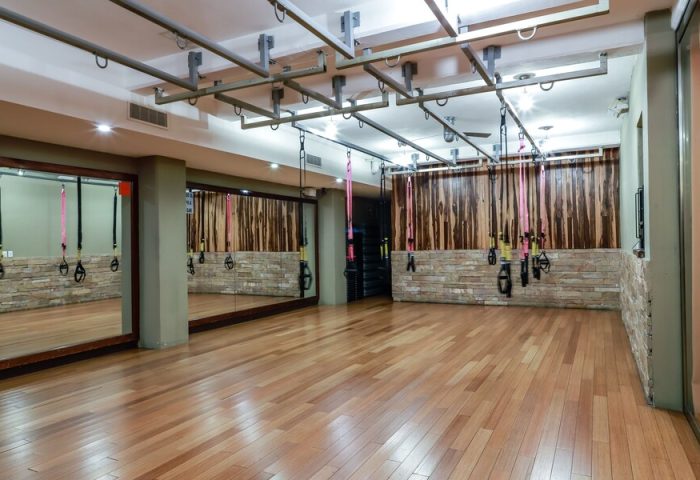 El Taj Oceanfront Condo Hotel's gym. Exercise room with wood floors, mirrors, and TRX suspension training equipment. Gay-friendly hotel.