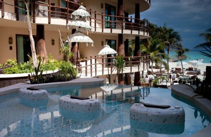 El Taj Oceanfront Condo Hotel pool view. Gay-friendly beachside hotel with ocean views, a luxurious pool, and tropical ambiance.