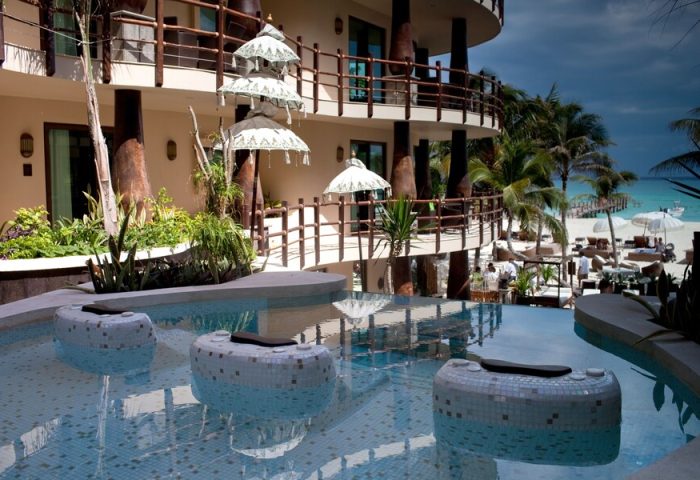 El Taj Oceanfront Condo Hotel pool view. Gay-friendly beachside hotel with ocean views, a luxurious pool, and tropical ambiance.