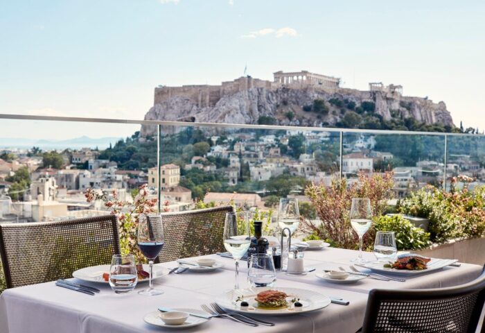 Electra Metropolis Hotel rooftop dining with Acropolis view. Gay-friendly hotel offers luxury travel experience in Athens, Greece.