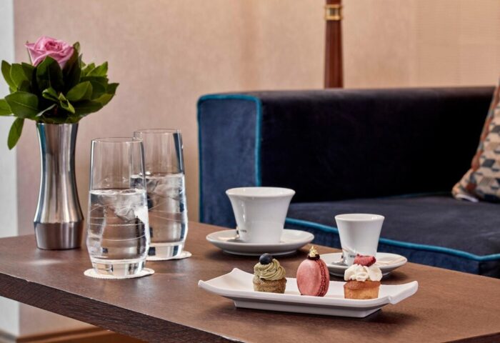 Electra Metropolis Hotel: Refreshments detail. Water, coffee, & pastries on a table. Gay-friendly hotel for gay men travel in Athens, Greece.