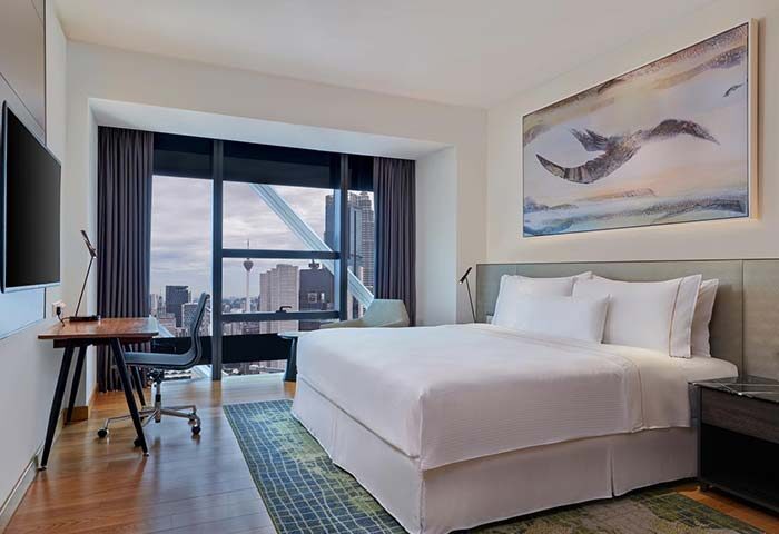 Element Kuala Lumpur hotel room with a city view. Gay-friendly travel accommodations, modern design, and comfortable bed.