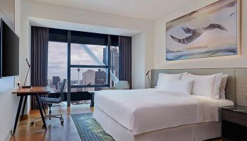Element Kuala Lumpur hotel room with a city view. Gay-friendly travel accommodations, modern design, and comfortable bed.