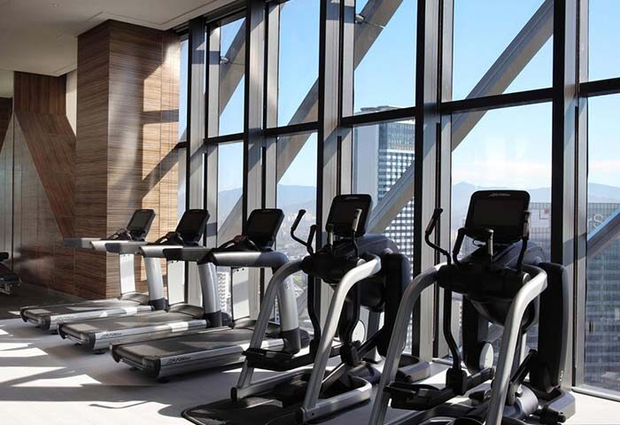 Element Kuala Lumpur gay-friendly hotel gym. Treadmills and elliptical machines face a large window with city views. Fitness for gay travelers.
