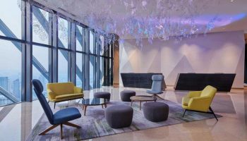 Element Kuala Lumpur, a gay-friendly hotel. Modern lobby with floor-to-ceiling windows, stylish seating, and unique lighting.