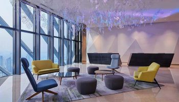 Element Kuala Lumpur hotel lobby. Gay-friendly hotel interior with modern seating, tall windows, and city view. Stylish design.