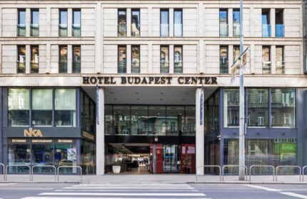 Eurostars Budapest Center Hotel entrance. Gay-friendly hotel with modern facade, street view, and pedestrian crossing. Ideal for gay travel in Budapest.