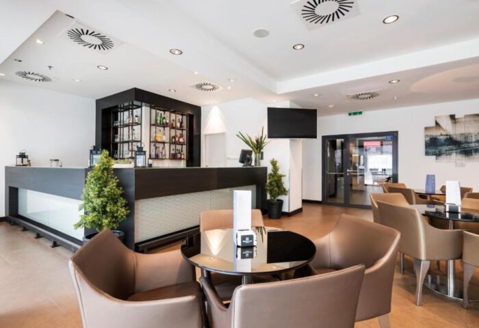 Eurostars Budapest Center gay-friendly hotel bar area. Modern design with tables, chairs, and a well-stocked bar. Ideal for gay travelers.