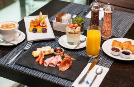 Eurostars Budapest Center's breakfast. A delicious spread with coffee, fruit, yogurt, juice, croissants, cheese, and ham. Gay-friendly hotel.