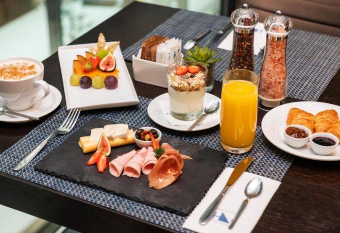 Eurostars Budapest Center's breakfast. A delicious spread with coffee, fruit, yogurt, juice, croissants, cheese, and ham. Gay-friendly hotel.