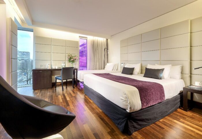 Eurostars Grand Central Hotel gay-friendly room. Modern design with a large bed, desk, and city view. Stylish stay for gay travelers in Munich.