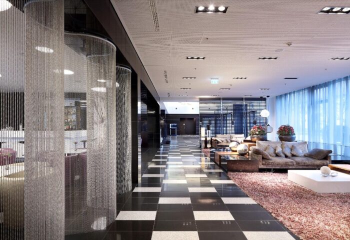 Eurostars Grand Central Hotel lobby. Modern design with black and white tiled floor, chain curtains, and lounge area. Gay-friendly hotel.