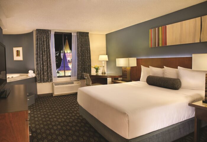Excalibur Hotel room interior. Gay-friendly hotel with a king-size bed, jacuzzi, and a view of the castle. Gay travel advice.