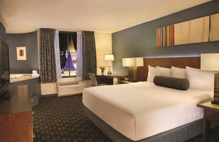 Excalibur Hotel room interior. Gay-friendly hotel with a king-size bed, jacuzzi, and a view of the castle. Gay travel advice.