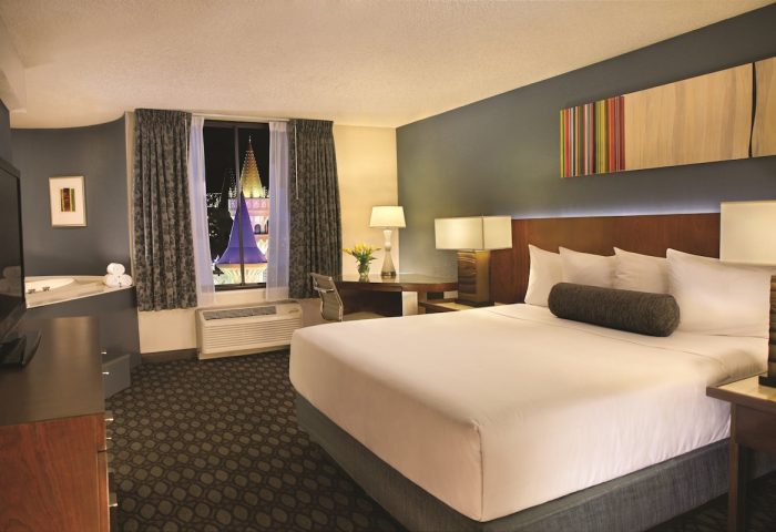 Excalibur Hotel room interior. Gay-friendly hotel with a king-size bed, jacuzzi, and a view of the castle. Gay travel advice.