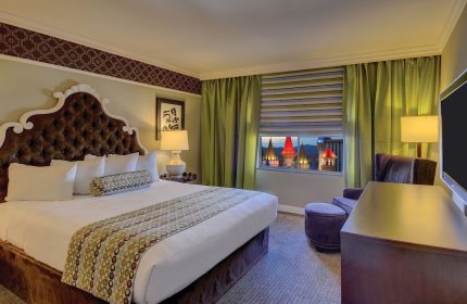 Excalibur Hotel room. Gay-friendly hotel with a plush bed, view of the castle spires. Ideal for gay men's travel to Las Vegas.
