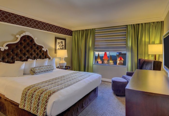 Excalibur Hotel room. Gay-friendly hotel with a plush bed, view of the castle spires. Ideal for gay men's travel to Las Vegas.