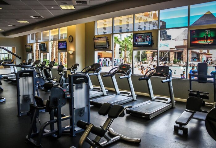 Excalibur Hotel gym. Gay-friendly hotel fitness center with treadmills, weights, and TVs. Pool view. Las Vegas gay travel advice.