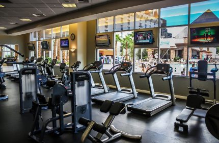 Excalibur Hotel gym. Gay-friendly hotel fitness center with treadmills, weights, and TVs. Pool view. Las Vegas gay travel advice.