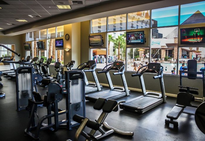 Excalibur Hotel gym. Gay-friendly hotel fitness center with treadmills, weights, and TVs. Pool view. Las Vegas gay travel advice.