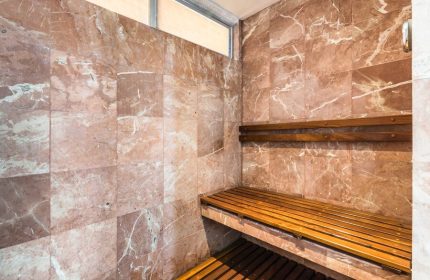 Sauna at Exe Cities Reforma, a gay-friendly hotel. Marble walls and wooden benches offer a relaxing experience in this Mexico City hotel.