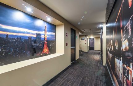 Exe Cities Reforma Hotel hallway. Gay-friendly hotel with city-themed decor. Hallway with Tokyo Tower mural. Modern design.