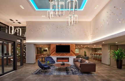 Fairfield by Marriott Montreal Downtown lobby. Gay-friendly hotel's stylish seating area with modern decor and fireplace. Great for gay travelers.