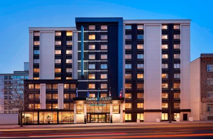 Fairfield by Marriott Montreal Downtown, a gay-friendly hotel. Modern building exterior at dusk, ideal for gay travelers.