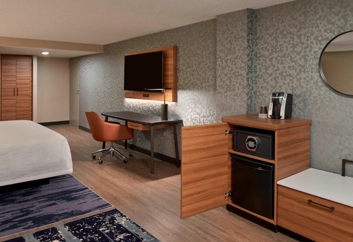 Fairfield by Marriott Montreal Downtown room. Desk, chair, TV, safe, mini-fridge, and coffee maker. Gay-friendly hotel room.