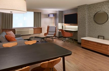 Fairfield by Marriott Montreal Downtown guest room. Gay-friendly hotel with modern design, desk, seating area, and TV.