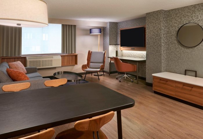 Fairfield by Marriott Montreal Downtown guest room. Gay-friendly hotel with modern design, desk, seating area, and TV.