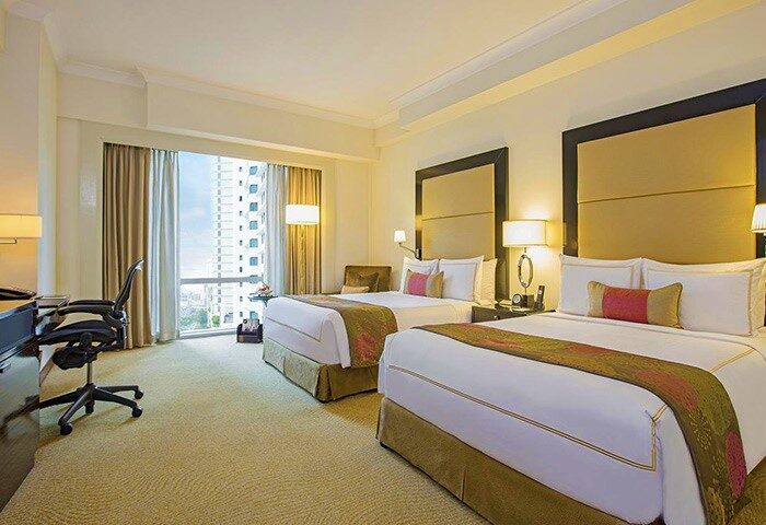 Fairmont Makati hotel room with two beds. Gay-friendly hotel in Makati with city view. Luxury hotel for gay men with restrictions.