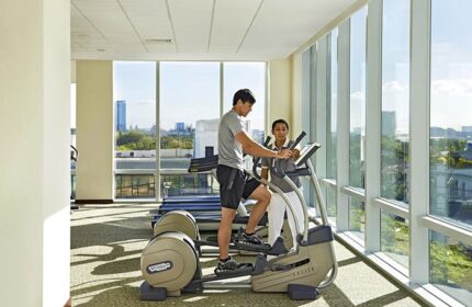 Fairmont Makati: Man exercising with a trainer at the gym. This gay-friendly hotel with restrictions offers fitness amenities for its guests.